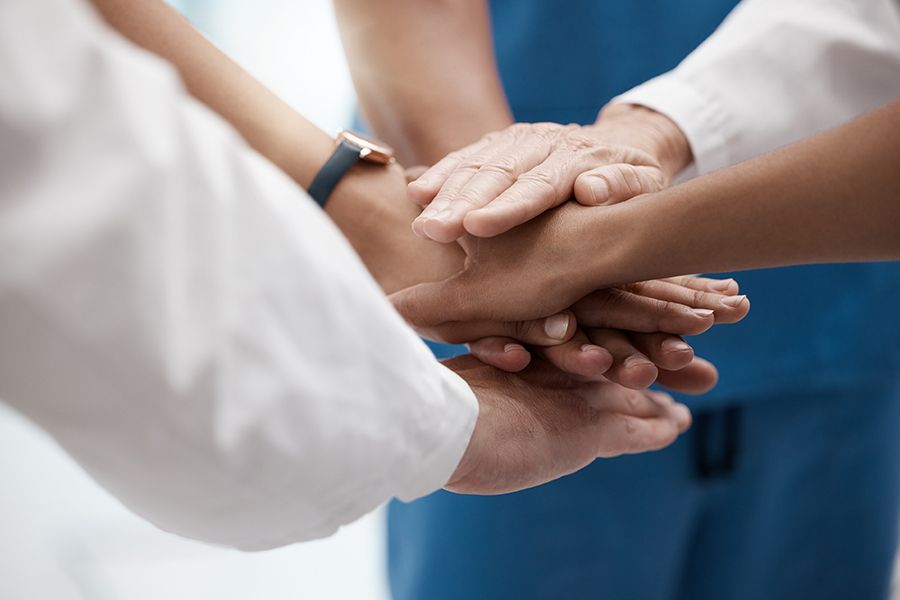 Hands of doctors working as team for success in healthcare at hospital